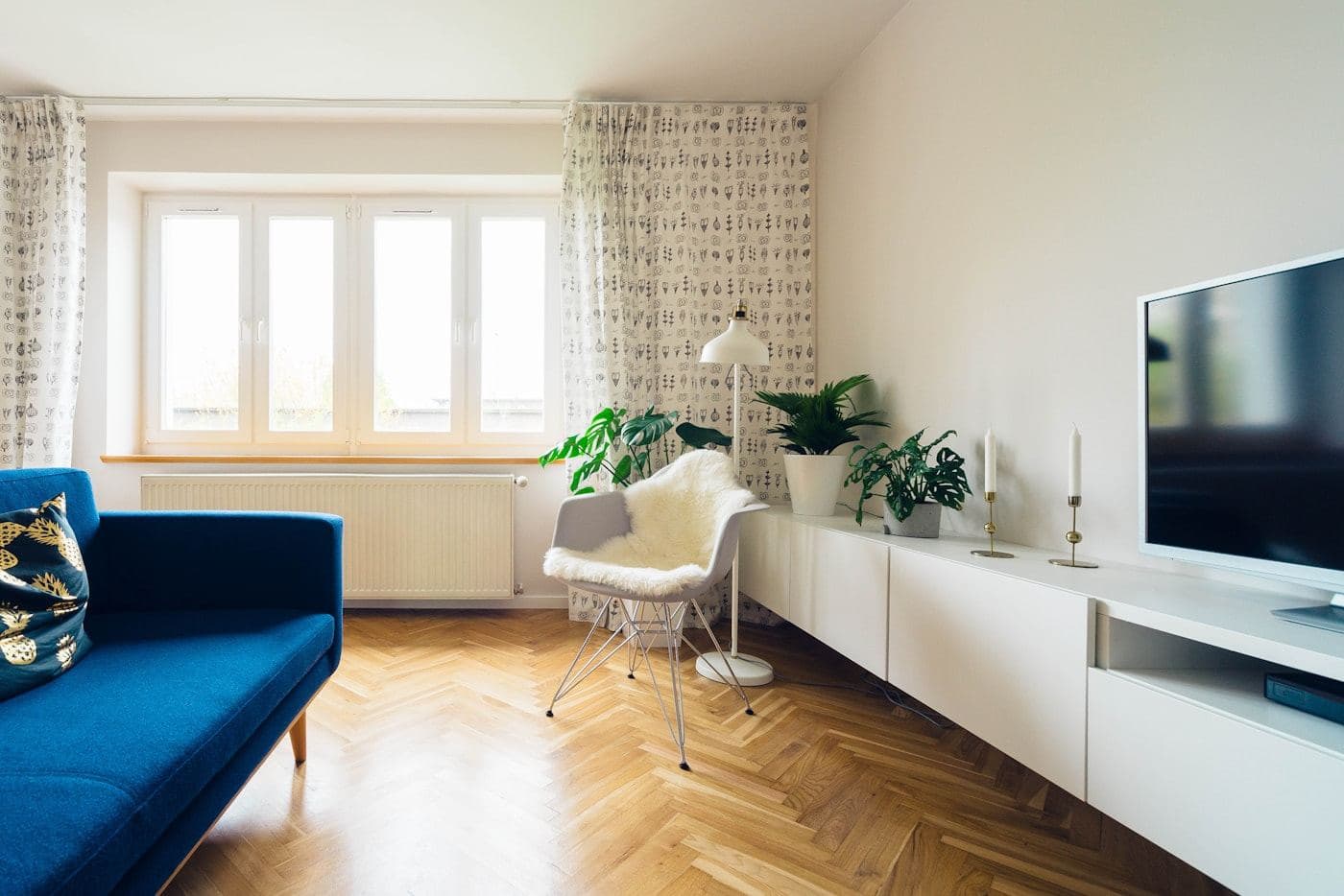 Loft living space with tall windows and a grey sofa