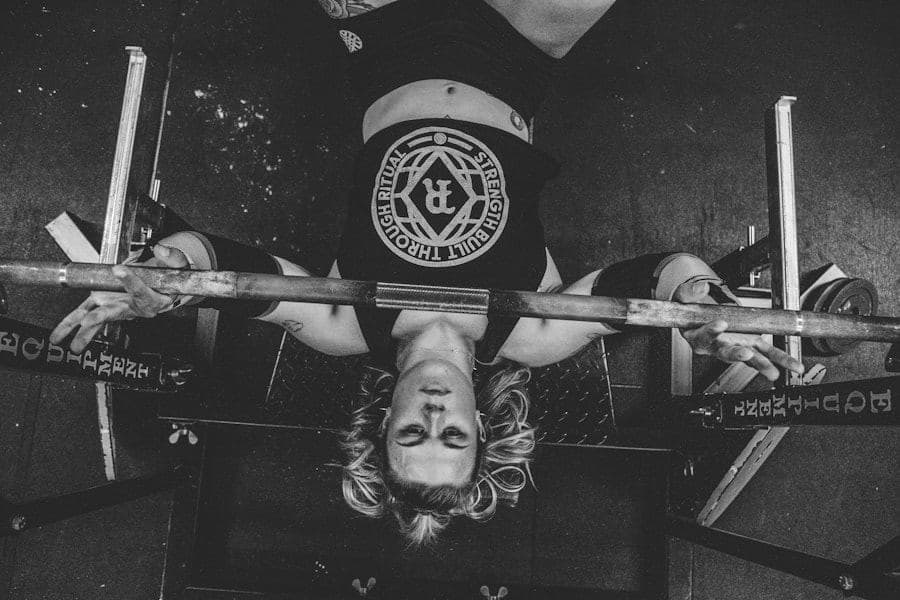 Black-and-white overhead view of a lifter on a bench press