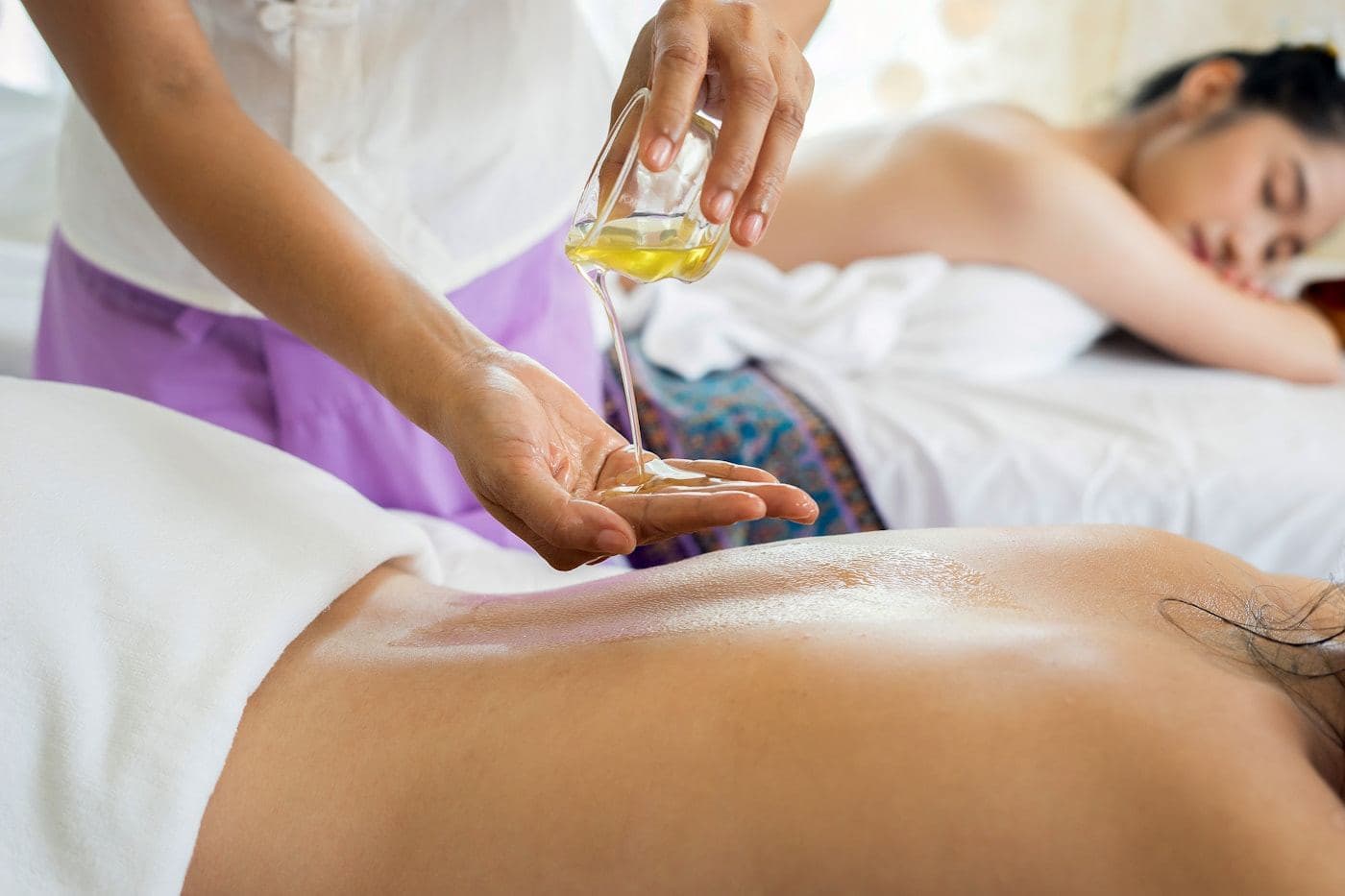Guest receiving an aromatherapy oil massage in the spa