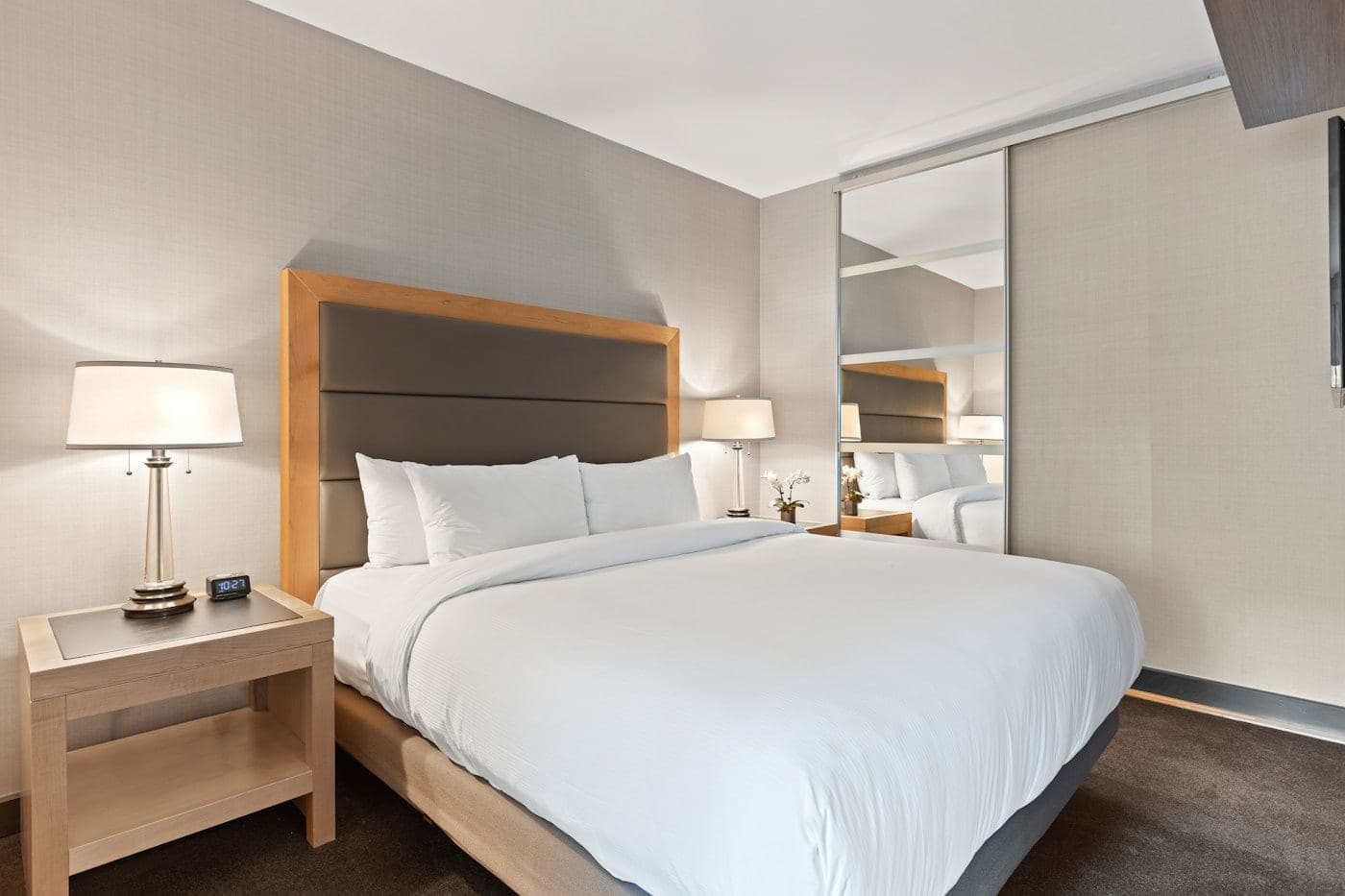 Superior suite with white linens and warm bedside lighting