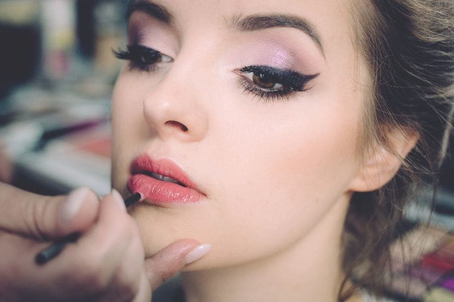 Makeup artist applying eye makeup to a client