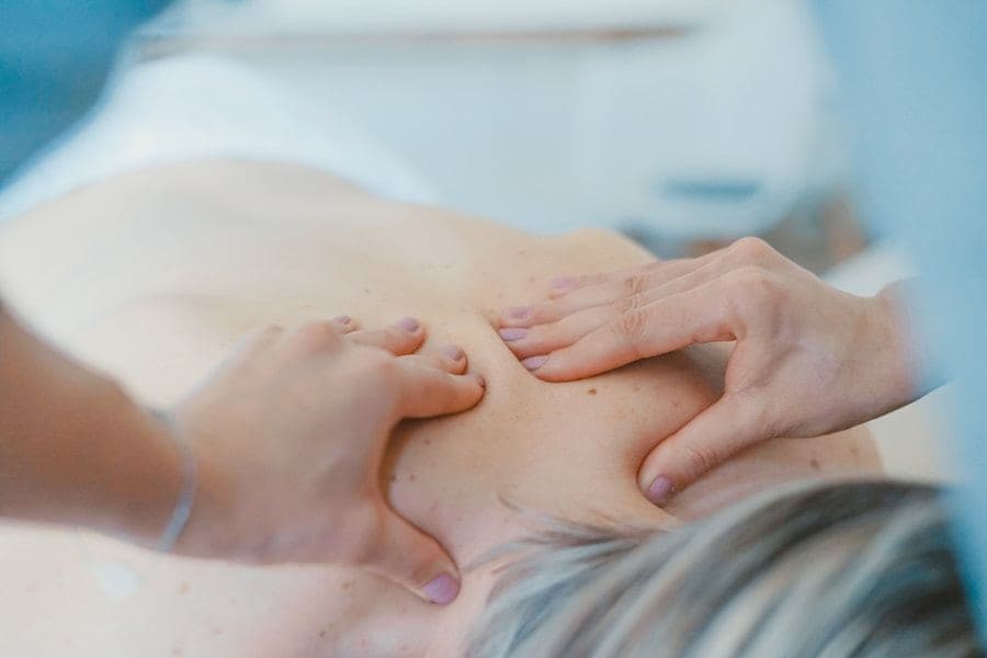 Therapist performing a shoulder massage