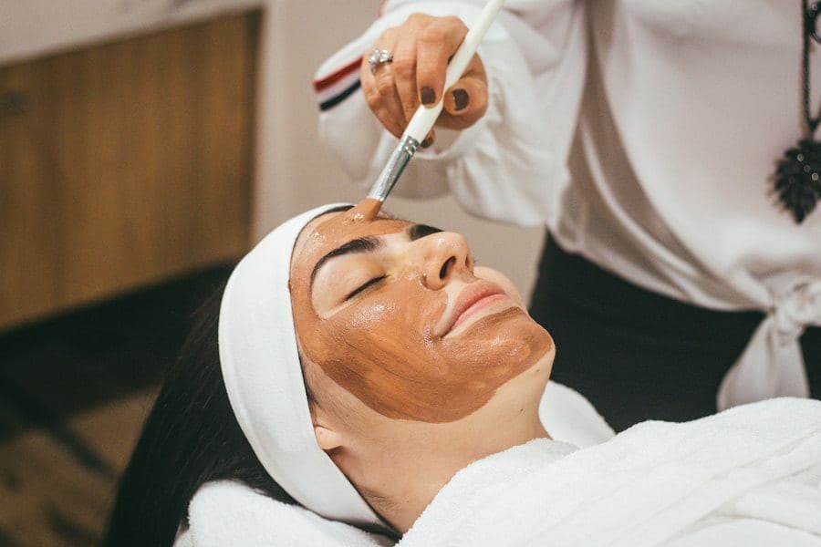 Client receiving a facial treatment wearing a white headband