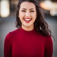 Smiling woman with long dark hair in a red top