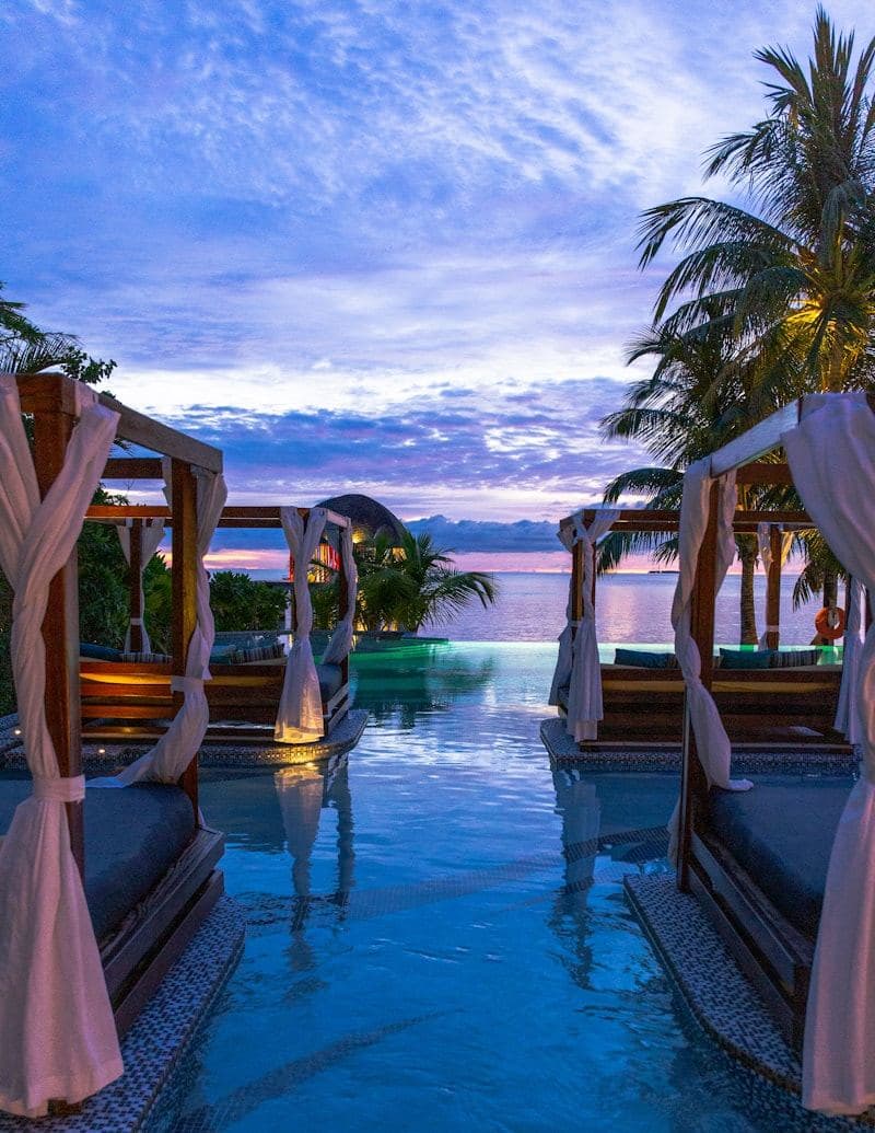 Terrace loungers overlooking the ocean at sunset